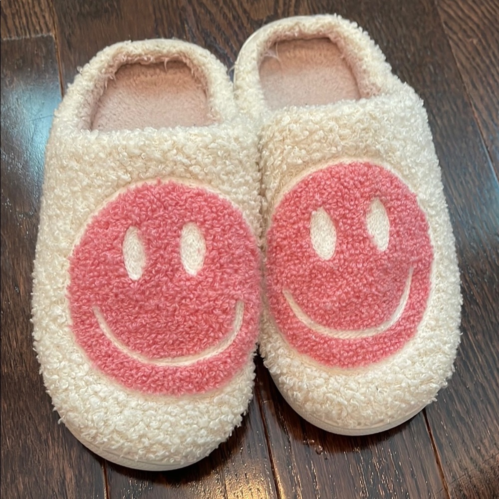 Woman’s cozy pink smiley face slippers
